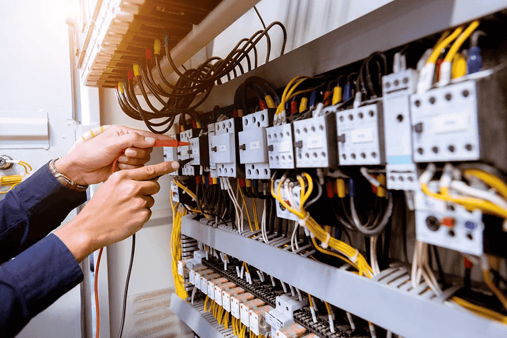 Electrician working on a circuit breaker panel.